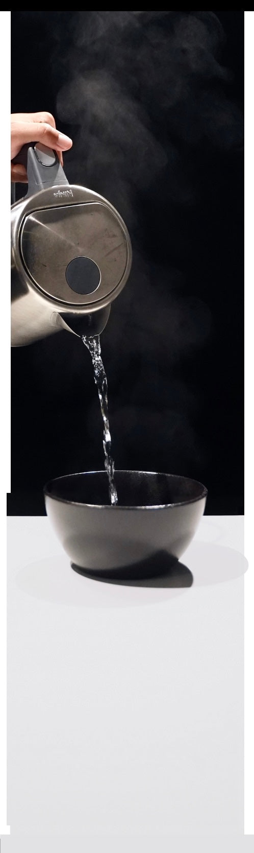 Boiling water pouring from a kettle into a bowl of CUT KITCHEN rice