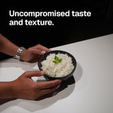 Two hands holding a black bowl of prepared Cut Kitchen rice beneath the words Uncompromised taste and texture