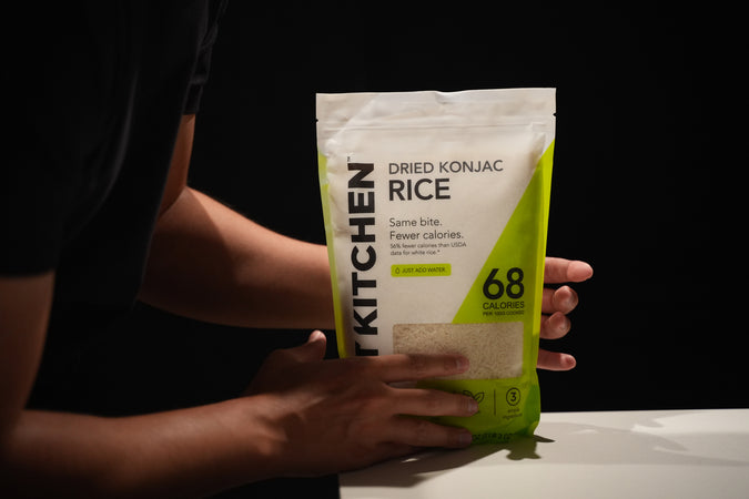 Hands holding Cut Kitchen rice on a black background